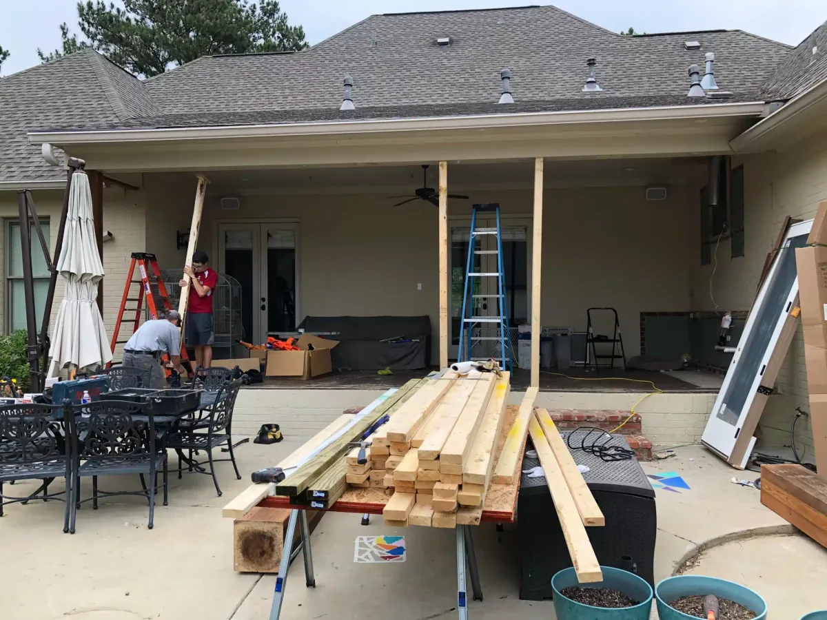 Framing a new home addition on a brick house before windows and doors are installed