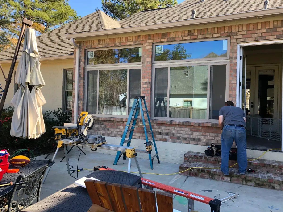 Installing new windows in the home addition with tools on the patio