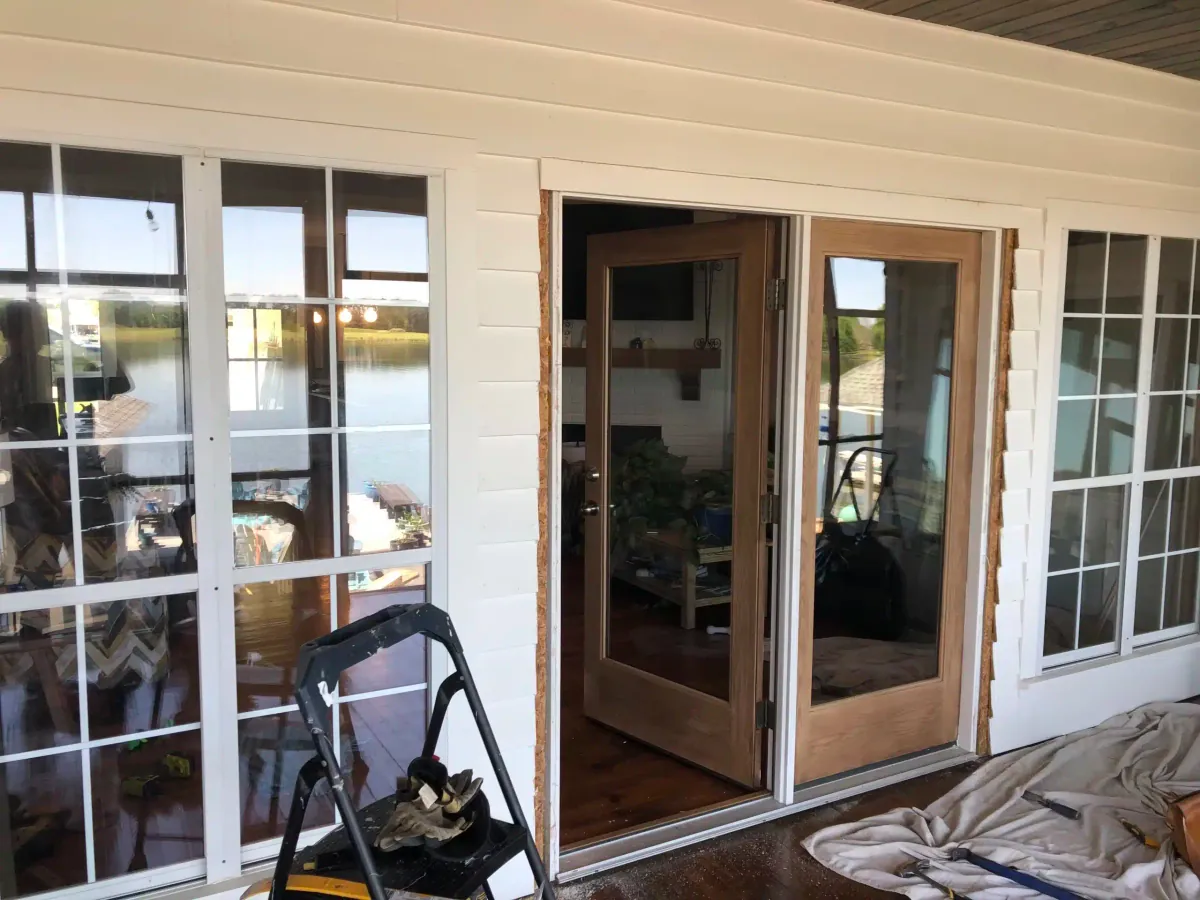 New wood French door installed in a white sunroom