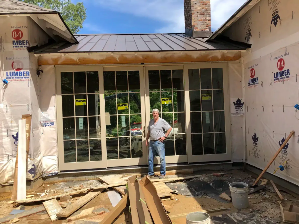 George Fowler, owner of Heritage Windows & Doors, standing in front of a newly installed wall of sunroom windows